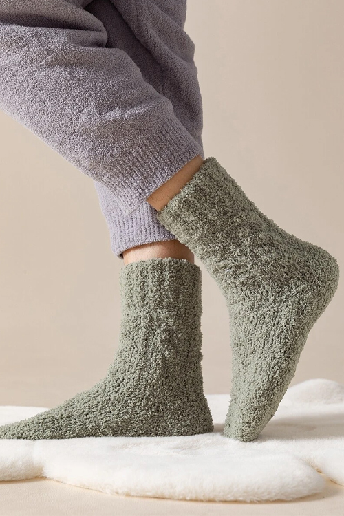 Green socks above the ankle-high, from thick fluffy material.