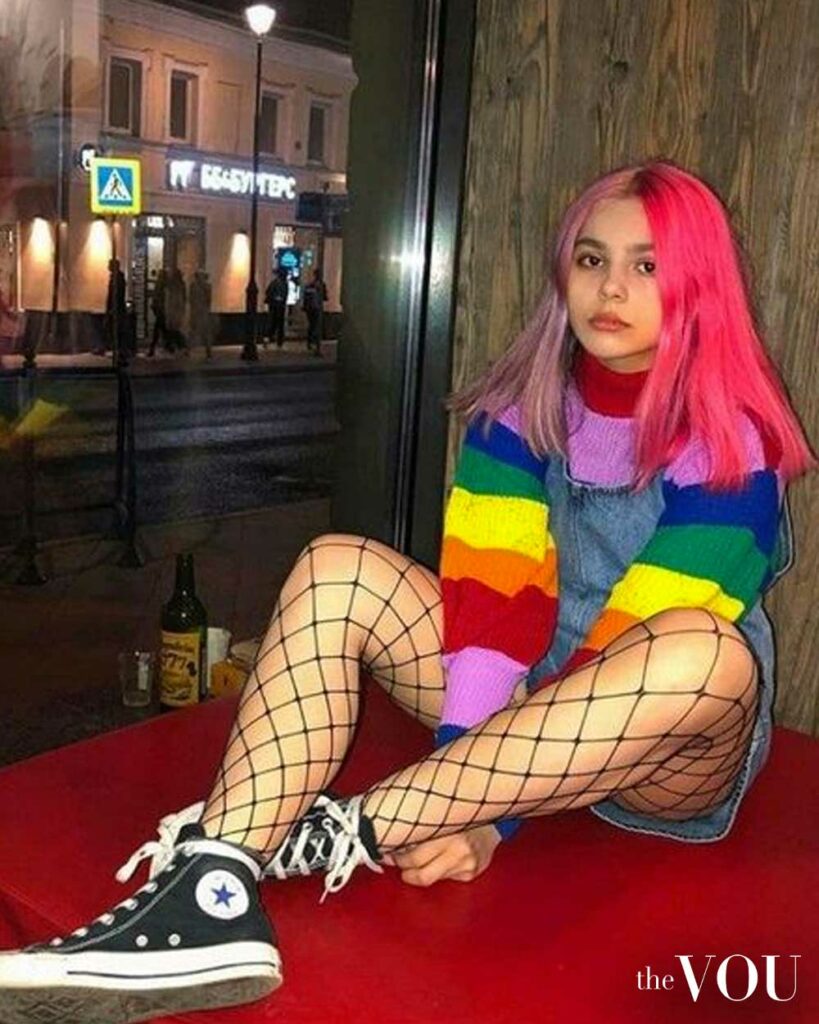 rainbow knitwear cardigan, denim jumper, fishnet thighs, sneakers