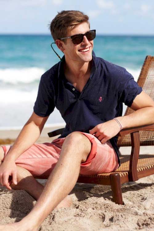 a man sitting on a chair on the beach in an Old Money casual aesthetic